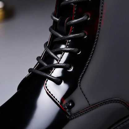 Close up of the laces and red-edged eyelets on high-gloss black boots