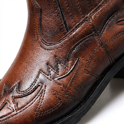 Close up of the tooled Western overlay stitching on cognac brown leather Chelsea boots