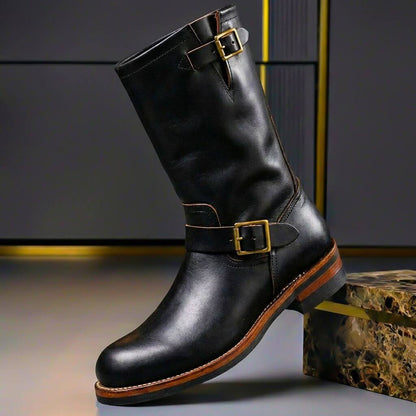 Obsidian black engineer boots with brass buckle straps and a low stacked heel