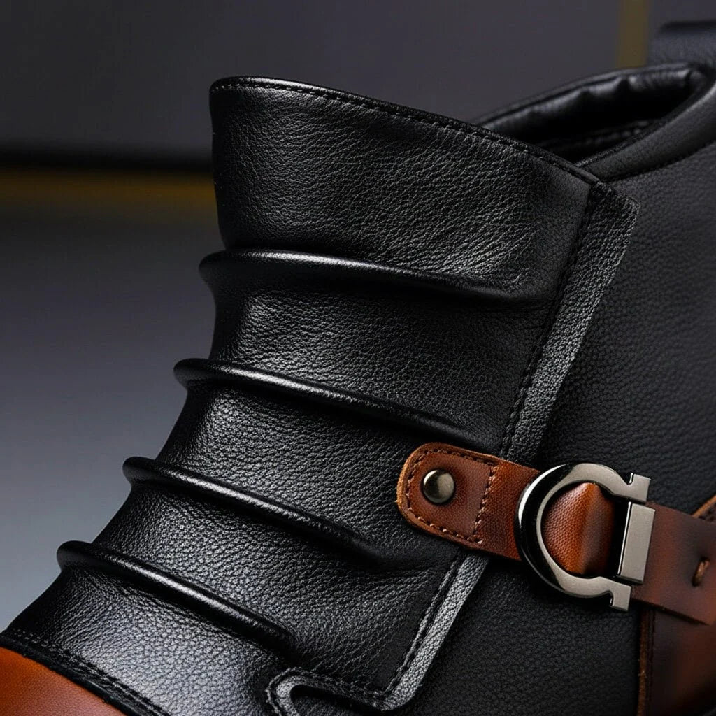 Close up of the ruched pebble-grain leather and silver buckle strap on cognac brown two-tone ankle boots