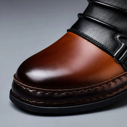 Polished cognac brown toe cap with contrast stitching and black rubber sole on two-tone ankle boots, close up
